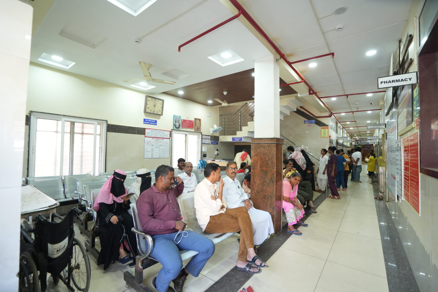 Patients waiting in the hospital reception and pharmacy area at Jayam Hrudayalaya